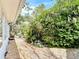 Well-maintained landscaping features a variety of plants along the brick pathway at 403 Wildwood Dr, Edgewater, FL 32132