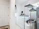 Functional laundry room with washer, dryer, storage, and convenient access to the outside at 403 Wildwood Dr, Edgewater, FL 32132