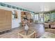 Inviting living room boasting wood floors and a large wicker cabinet for storage at 403 Wildwood Dr, Edgewater, FL 32132