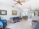 Open living space featuring tile flooring, ceiling fan and casual furnishings for relaxing and entertaining at 403 Wildwood Dr, Edgewater, FL 32132