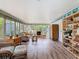Bright living room featuring wood floors, natural light, and wicker furniture at 403 Wildwood Dr, Edgewater, FL 32132