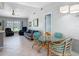 Bright living and dining area featuring tile floors, comfortable seating, and a glass table at 403 Wildwood Dr, Edgewater, FL 32132