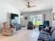 Open living room area featuring tile floors, ceiling fan, and a relaxed seating arrangement at 403 Wildwood Dr, Edgewater, FL 32132