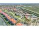 Panoramic view of the property with community pool, tennis courts, lush landscaping, and convenient parking areas at 407 Bouchelle Dr # 205, New Smyrna Beach, FL 32169