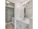 Bathroom with a shower, white vanity, and a large mirror, offering a bright and functional space at 407 Bouchelle Dr # 205, New Smyrna Beach, FL 32169