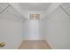 Walk-in closet featuring shelving and carpeted floor, providing ample storage at 407 Bouchelle Dr # 205, New Smyrna Beach, FL 32169
