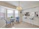 Cozy dining area with window, barstool seating, and modern light fixture at 407 Bouchelle Dr # 205, New Smyrna Beach, FL 32169