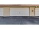 A two-car garage exterior with a clean, sealed door and tile roof at 407 Bouchelle Dr # 205, New Smyrna Beach, FL 32169