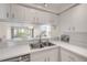 Bright and clean kitchen area overlooking the rest of the home, featuring a stainless steel sink at 407 Bouchelle Dr # 205, New Smyrna Beach, FL 32169
