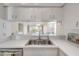 Bright and airy kitchen with a stainless steel sink, white cabinets, and modern fixtures at 407 Bouchelle Dr # 205, New Smyrna Beach, FL 32169