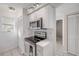 Modern kitchen with white cabinets, stainless steel appliances, and a well-lit cooking area at 407 Bouchelle Dr # 205, New Smyrna Beach, FL 32169
