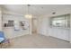 Open-concept living area with bar seating, modern lighting, and built in shelving at 407 Bouchelle Dr # 205, New Smyrna Beach, FL 32169