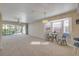 Open living space with balcony access, plush carpet, and inviting seating area at 407 Bouchelle Dr # 205, New Smyrna Beach, FL 32169