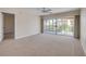 Bright bedroom with neutral carpet, and sliding glass doors to the balcony that let in plenty of natural light at 407 Bouchelle Dr # 205, New Smyrna Beach, FL 32169