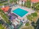 Aerial view of a sparkling pool with lounge chairs and a nearby shade pavilion at 407 Bouchelle Dr # 205, New Smyrna Beach, FL 32169