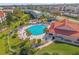 Aerial view of a community pool surrounded by palm trees and well-maintained landscaping at 407 Bouchelle Dr # 205, New Smyrna Beach, FL 32169
