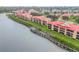 Aerial shot of waterfront community with red tile roofs and wooden walkways at 407 Bouchelle Dr # 205, New Smyrna Beach, FL 32169