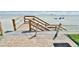 Beach access via wooden stairs with railings, leading to the sandy shore at 4225 S Atlantic Ave # 2070, New Smyrna Beach, FL 32169