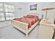 Cozy bedroom featuring a large window and a comfortable bed with patterned bedding at 4225 S Atlantic Ave # 2070, New Smyrna Beach, FL 32169