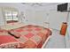 Comfortable bedroom with a large bed, mirrored dresser, and natural light at 4225 S Atlantic Ave # 2070, New Smyrna Beach, FL 32169