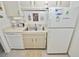 Functional kitchen featuring white appliances, including a dishwasher and refrigerator at 4225 S Atlantic Ave # 2070, New Smyrna Beach, FL 32169