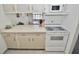 Kitchen with a view of the dining area, microwave, and stove with countertop space at 4225 S Atlantic Ave # 2070, New Smyrna Beach, FL 32169