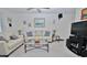 Comfortable living room with cozy seating, glass coffee table, and view of the TV at 4225 S Atlantic Ave # 2070, New Smyrna Beach, FL 32169