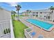 Community pool area with lounge chairs and lush landscaping near the beach at 4225 S Atlantic Ave # 2070, New Smyrna Beach, FL 32169