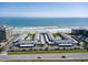 Drone shot of Colony Beach Club showcasing community parking, buildings and beach access at 4225 S Atlantic Ave # 2150, New Smyrna Beach, FL 32169