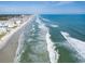 Aerial view of a wide, sandy beach with the ocean, and the condos along the coastline at 4225 S Atlantic Ave # 2150, New Smyrna Beach, FL 32169