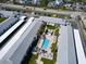 Aerial view of condos featuring a large pool, carports, and lush landscaping close to the beach at 4225 S Atlantic Ave # 2150, New Smyrna Beach, FL 32169