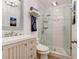 Bathroom featuring a glass shower, framed mirror, and elegant chandelier at 4225 S Atlantic Ave # 2150, New Smyrna Beach, FL 32169