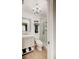 Bathroom featuring a glass shower, framed mirror, and elegant chandelier at 4225 S Atlantic Ave # 2150, New Smyrna Beach, FL 32169
