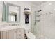 Bathroom featuring a glass shower, framed mirror, and elegant chandelier at 4225 S Atlantic Ave # 2150, New Smyrna Beach, FL 32169