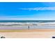 Scenic view of a sunny beach with a person fishing in the ocean at 4225 S Atlantic Ave # 2150, New Smyrna Beach, FL 32169