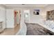 Bedroom featuring a tufted headboard, TV, and wood floors at 4225 S Atlantic Ave # 2150, New Smyrna Beach, FL 32169