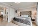 Bedroom featuring a tufted headboard, shuttered window, and light wood floors at 4225 S Atlantic Ave # 2150, New Smyrna Beach, FL 32169