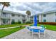 Condominium exterior view of community green space with outdoor seating area under cloudy skies at 4225 S Atlantic Ave # 2150, New Smyrna Beach, FL 32169