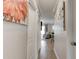 Hallway view with decorative paintings on the wall leading to the living room at 4225 S Atlantic Ave # 2150, New Smyrna Beach, FL 32169