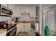 Compact kitchen design with stainless steel appliances and contemporary finishes at 4225 S Atlantic Ave # 2150, New Smyrna Beach, FL 32169