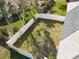 Aerial view of a fenced backyard with grass and a small patio area, offering privacy and outdoor space at 4583 Barnacle Dr, Port Orange, FL 32127
