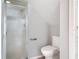 This bright bathroom includes a glass enclosed shower and white toilet at 4583 Barnacle Dr, Port Orange, FL 32127