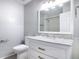 Bathroom featuring a marble countertop, framed mirror, and white cabinetry at 4583 Barnacle Dr, Port Orange, FL 32127