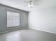 Bright bedroom with tile floors, neutral walls, and a ceiling fan, creating a serene and inviting space at 4583 Barnacle Dr, Port Orange, FL 32127