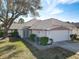 Charming single-story home featuring a well-manicured lawn, mature tree, and a two-car garage at 4583 Barnacle Dr, Port Orange, FL 32127