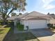 Charming home with a two-car garage, well-maintained lawn, and inviting curb appeal in a quiet residential neighborhood at 4583 Barnacle Dr, Port Orange, FL 32127
