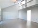 Bright living room with a vaulted ceiling, tile floors, and an open staircase to the second floor at 4583 Barnacle Dr, Port Orange, FL 32127
