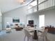 A styled living room with neutral furniture, dining area and an open view to the second floor at 4583 Barnacle Dr, Port Orange, FL 32127