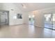 Open-concept living room featuring vaulted ceilings, tile floors, and sliding glass doors to the outside at 4583 Barnacle Dr, Port Orange, FL 32127