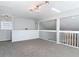 Loft showcasing railings, carpeting and two windows, creating a versatile and inviting space at 4583 Barnacle Dr, Port Orange, FL 32127